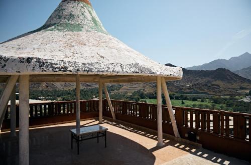 a gazebo with a bench on a deck at Mountain Majesty 4 Bed Home - BBQ Retreat in Masāfī