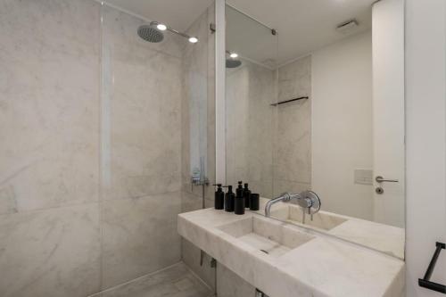 a white bathroom with a sink and a shower at Casa Boma Lisboa - Sea View Apartment With Private Sunny Terrace - Alges I in Algés