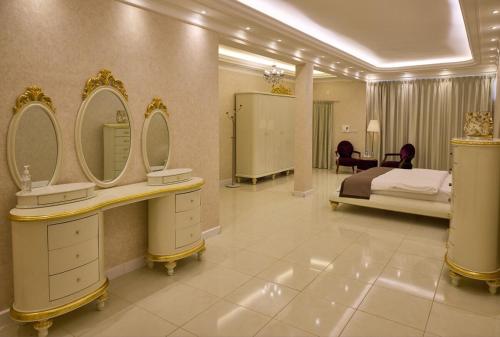 a large bathroom with two sinks and a bed at Mountain Majesty 4 Bed Home - BBQ Retreat in Masāfī
