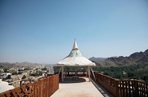 a gazebo on a wooden deck with a view at Mountain Majesty 4 Bed Home - BBQ Retreat in Masāfī