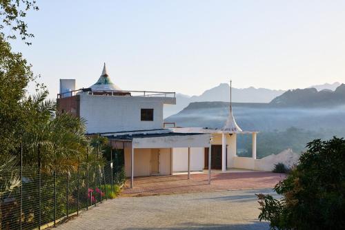 a white house with a view of the mountains at Mountain Majesty 4 Bed Home - BBQ Retreat in Masāfī
