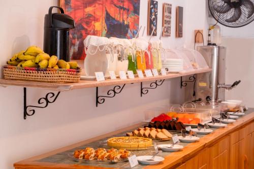 a buffet line with fruit and other food on it at Pousada Chez Toi in Jericoacoara