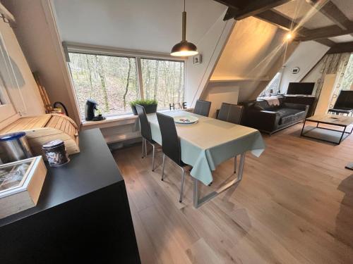 a kitchen and living room with a table and chairs at Chalet 146 Arrivée in Durbuy