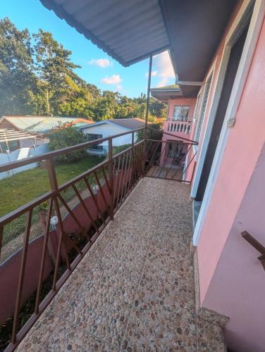a balcony of a house with a walkway at Departamento Ángeles del Arenal #1 in Fortuna