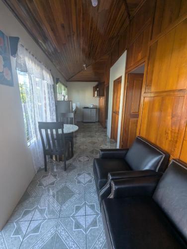 a living room with a couch and a table at Departamento Ángeles del Arenal #1 in Fortuna