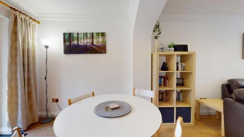 a living room with a white table and a couch at Rewley Road in Oxford