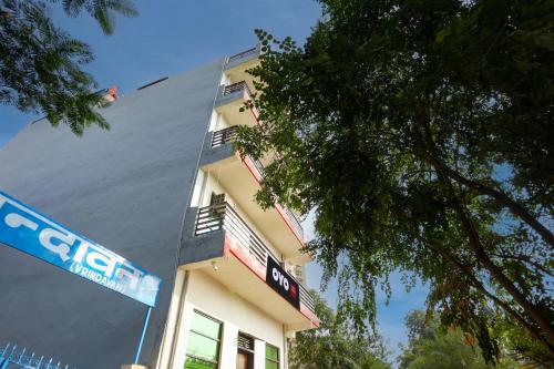 a building with a sign on the side of it at Hotel O Rajhans in Gurgaon