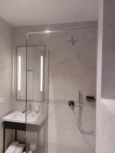 a bathroom with a shower and a sink at Mulaj Hotel in Tirana