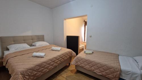 a bedroom with two beds with towels on them at Rooms Vinko, Međugorje in Međugorje