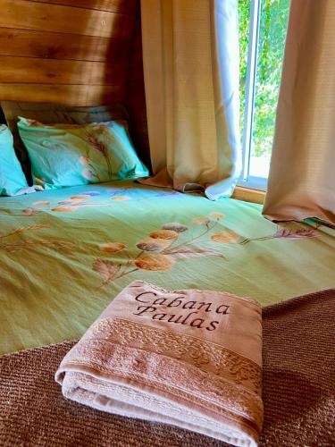 a bed with a happy birthday sign on it at Chalé Barril com cozinha in São Francisco do Sul