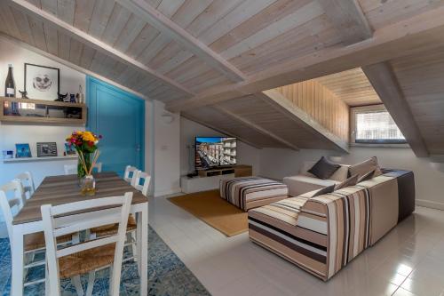 a living room with a couch and a table at Mansarda del Corso in Sorrento