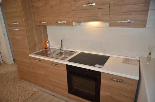 a kitchen with a sink and a stove at Palazzo Maggiore Suite B in Noale