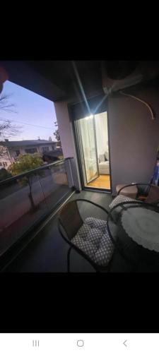 a room with a glass table and chairs and a window at Stan na dan Banja luka Mejdan in Hiseti