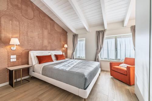 a bedroom with a large bed and a chair at Trilocale Atlantico Treviglio Upper Stay in Treviglio