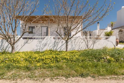 a white house with a white fence and trees at Touch Naxos Sunset in Galanado