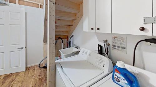 a laundry room with a washer and dryer at Diamond Lakehouse | SUP, Canoe, BBQ, Aurora Magic in Highland Grove
