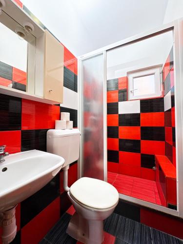 a bathroom with a toilet and a sink and a shower at Apartments Kiro in Milna