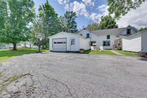 an empty driveway in front of a house with a basketball hoop at Lakefront Retreat with Shared Dock and Fire Pit! in Swanton