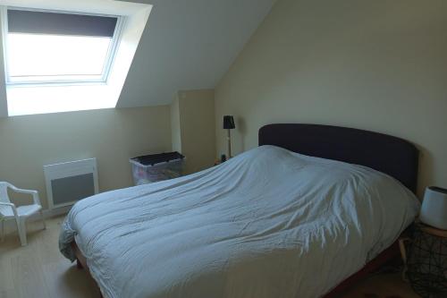 une chambre avec un grand lit avec une fenêtre dans l'établissement Nice T3 with balcony - 5 mn from the beach, à Merlimont