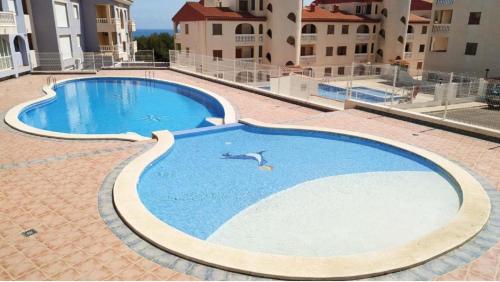 a large swimming pool in the middle of a building at Marcotin Piscina playa y montaña in Alcossebre