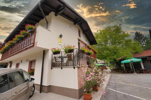 a building with flowers on the side of it at Domačija Bubec in Ilirska Bistrica