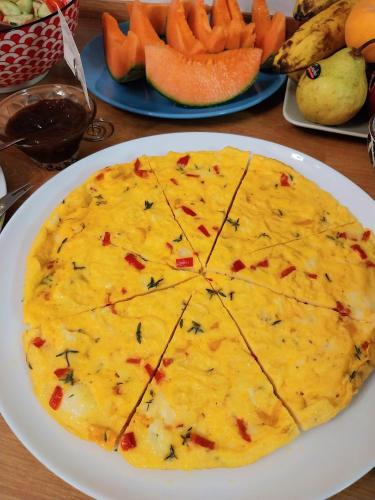 a cheese pizza on a white plate on a table at Villa Bellavista Alba, B&B in Alba