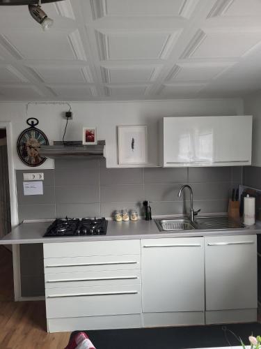 a kitchen with white cabinets and a counter top at Appartment B 40 in Pirmasens