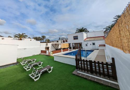 a patio with lawn chairs and a swimming pool at Ca la Consol in El Poblenou del Delta