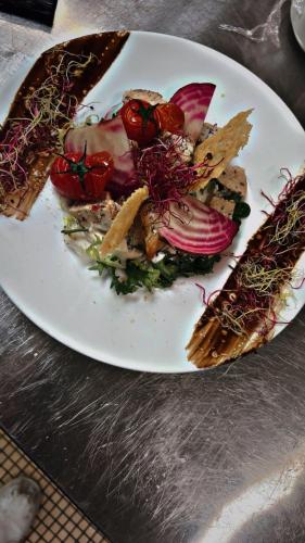 a white plate of food on a table at ibis Cambrai in Cambrai