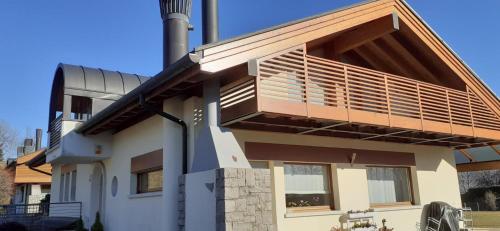 a house with a balcony on the side of it at Mansarda da Nonna Berbelina in Belluno