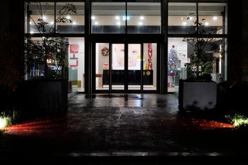a store front at night with its doors open at LHI Healthy Hotel Lecce in Lecce