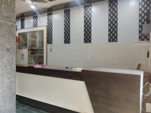 a bathroom with a counter and a mirror at Hotel Goverdhan - Walking to Raja Ki Mandi Railway and 3km from ISBT in Agra