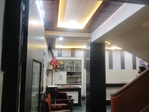 a hallway with a room with a table and chairs at Hotel Goverdhan - Walking to Raja Ki Mandi Railway and 3km from ISBT in Agra