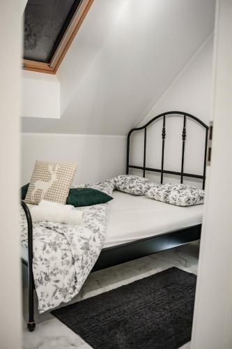a bedroom with a bed with a black frame and pillows at Bieszczadzka Wataha in Paszowa