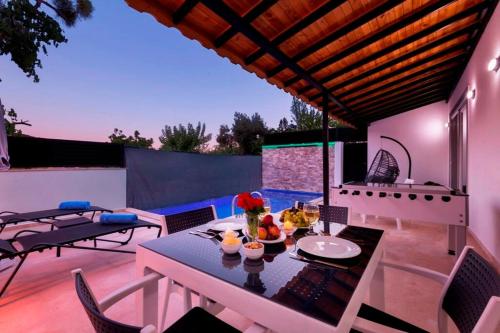 eine Terrasse mit einem Tisch und Stühlen auf einer Terrasse in der Unterkunft Villa Zafar - Private outdoor pool in Kaş