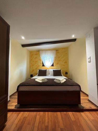 a bedroom with a large bed with a window at Apartment Kaucic in Banjole