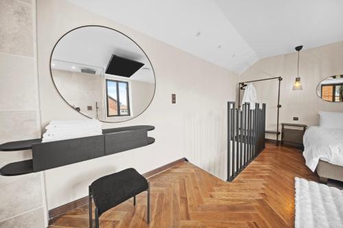 a bedroom with a bed and a mirror on the wall at Maison d'architecte avec Jacuzzi, Quartier Prémontrés in Pont-à-Mousson