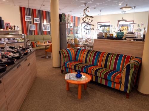 a room with a couch and a table in a store at Altstadthotel "Garni" Grimma in Grimma