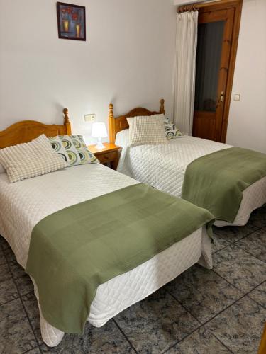 Ένα ή περισσότερα κρεβάτια σε δωμάτιο στο Hostal San José Naval