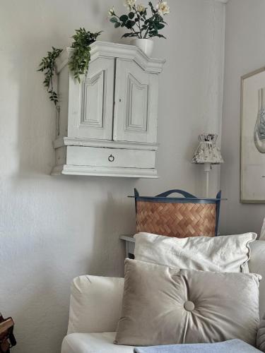 a room with a white cabinet and a couch at Fairy Lake Retreat! Uniquely Located House with Dock! in Bålsta