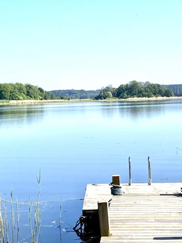 a dock on a large body of water at Fairy Lake Retreat! Uniquely Located House with Dock! in Bålsta