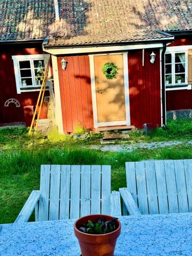 a house with a bowl of fruit in front of it at Fairy Lake Retreat! Uniquely Located House with Dock! in Bålsta