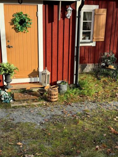 a front door of a house with a wreath on it at Fairy Lake Retreat! Uniquely Located House with Dock! in Bålsta
