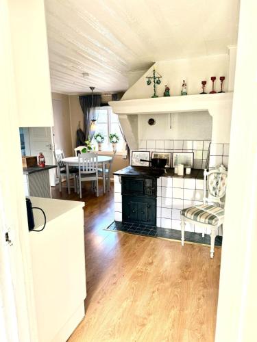 a kitchen and living room with a table and chairs at Fairy Lake Retreat! Uniquely Located House with Dock! in Bålsta