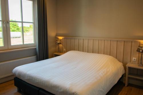 Katil atau katil-katil dalam bilik di Wertemerhoeve Vakantiewoningen