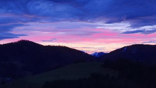 a sunset in the mountains with trees and mountains at Mitterhirschberg, Familie Schweighuber in Waidhofen an der Ybbs