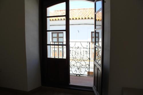 an open door with a view of a balcony at Pórtico del Azahín in Cazalla de la Sierra