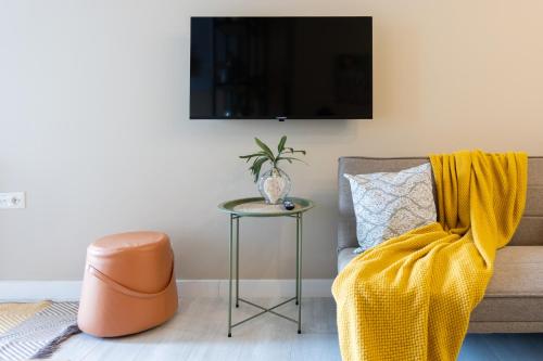 a living room with a chair and a table at Boho apartment studio in Batumi