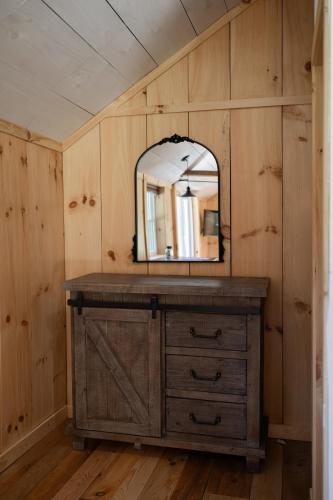 a mirror on top of a dresser in a room at Couples Retreat - The HayLoft- Rustic Escape For 2 in Oakland