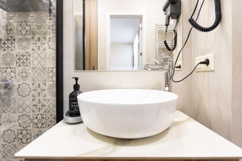 a bathroom with a large white bowl sink on a counter at Boho apartment studio in Batumi